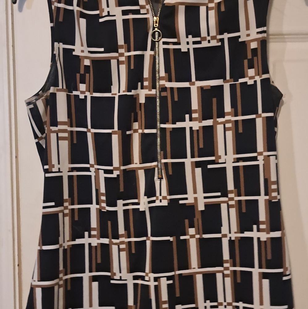 Navy,tan and white sleeveless top with zipper. NWOT. smoke and pet free home.